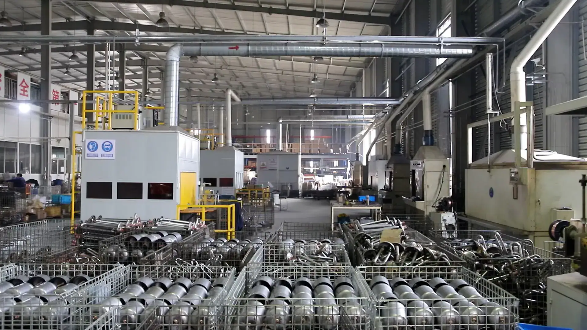Industrial manufacturing facility with machinery, metal parts, and production equipment in a large factory setting.