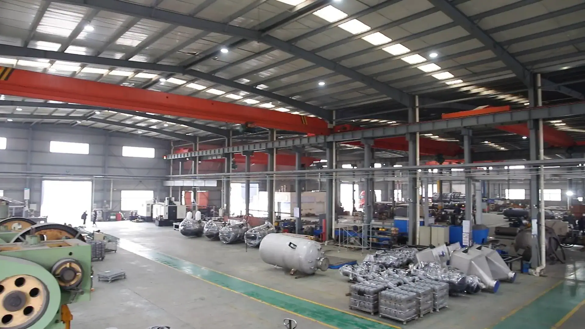 Modern manufacturing factory with machinery, assembly lines, and equipment for industrial production. Spacious warehouse environment with organized workstations and high ceilings.