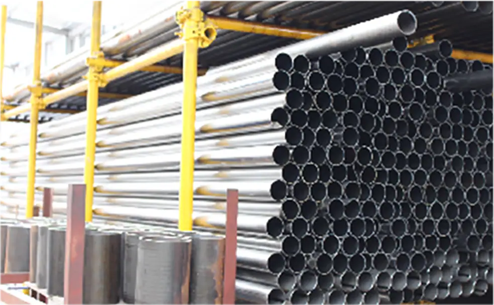 Steel pipes stacked in a warehouse, ready for construction or industrial use.
