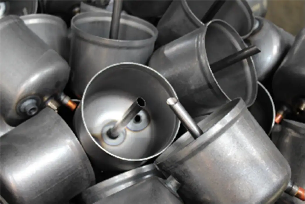 Cans with straws, metallic beverage containers, stacked in a pile, close-up view.