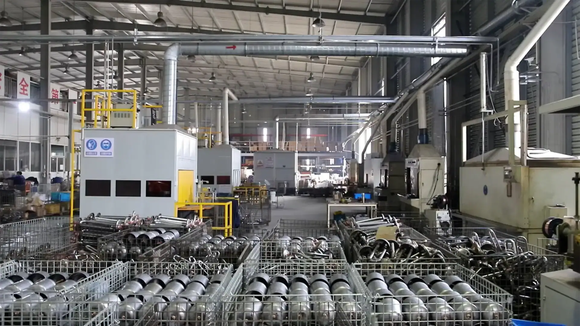 Industrial manufacturing facility with machinery and metal components, showcasing automated production processes and equipment used in manufacturing.