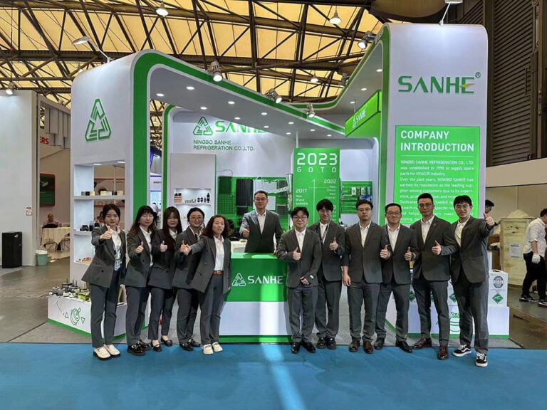 Ningbo SANHE Refrigeration Co. Ltd. booth at 2023 CRH Shanghai exhibition, showcasing HVAC and refrigeration solutions. The team is dressed professionally, standing in front of the SANHE booth with gr.