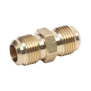 Close-up of a brass pipe fitting with threaded ends, used in plumbing and HVAC systems.
