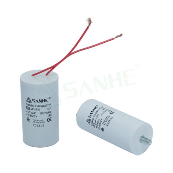 Two white CBB60-AC motor capacitors with red and black wires, used in HVAC systems for motor starting and running.